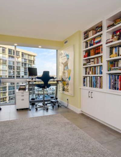 A home office with bookshelves and a desk.